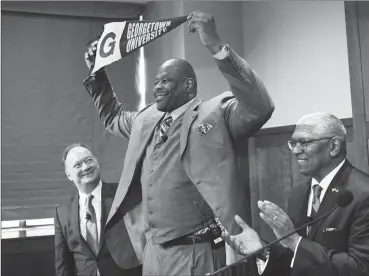  ?? By Jonathan Newton / The Washington Post ?? Patrick Ewing recreates the photograph of when he signed as a player during the press conference where he is introduced as the new head coach of the Georgetown University men's basketball team with University President John DeGioia, left, and Athletic Director Lee Reed on April 5.