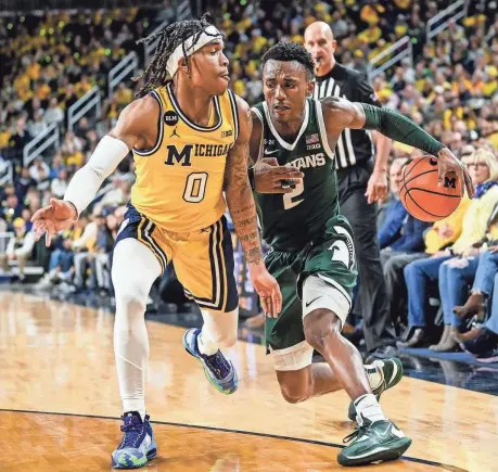  ?? NICK KING/LANSING STATE JOURNAL ?? Michigan State’s Tyson Walker, right, winless in two tries at Crisler Center, said the Spartans need road wins, particular­ly Saturday night in Ann Arbor. “It's not easy,” he said.