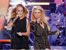  ?? [PHOTO BY WADE PAYNE, INVISION/AP FILE] ?? Carrie Underwood, left, and Miranda Lambert perform at the 2014 CMT Music Awards.