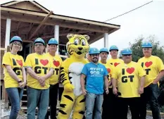  ?? LAURA BARTON/POSTMEDIA NEWS ?? Giant Tiger has teamed up with Habitat for Humanity Niagara, donating $10,000 towards a home build for Juan Pablo, in blue, and his family on Sauer Avenue in Welland.