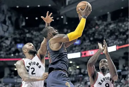  ?? FRANK GUNN/THE CANADIAN PRESS ?? Cleveland Cavaliers forward LeBron James (23) goes to the net past Toronto Raptors forward P.J. Tucker (2) and forward Serge Ibaka (9) during the second half of Game 4 in Toronto on Sunday. Cleveland won the series, defeating the Raptors 109-102.