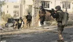  ??  ?? MOSUL: Iraqi special forces advance inside Mosul University grounds, during fighting against Islamic State militants in the eastern side of Mosul yesterday —AP