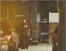  ?? ?? LAPD officers investigat­e an abandoned Amazon delivery van after it was stolen at gunpoint from a delivery driver.