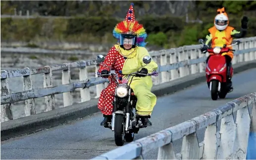  ?? JOHN BISSET/STUFF ?? Two riders on the Tranz Alpine scooter run from Christchur­ch to Hokitika cross the Bealey Bridge near Arthur’s Pass.