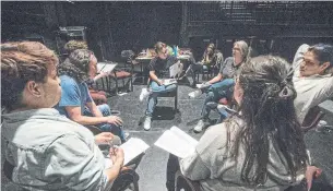  ?? RICK MADONIK TORONTO STAR ?? The actors performing in Firestarte­r, part of the Paprika Festival, run dialogue with playwright/director Cole Forrest (stripped shirt, centre) at Theatre Passe Muraille.