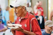  ??  ?? Chris Whitestar eats during a May 24 lunch of rib-eye steak sandwiches, coleslaw and beans made by the Oklahoma Cattlemen’s Associatio­n and the Oklahoma Beef Council at the Homeless Alliance’s WestTown campus in Oklahoma City.