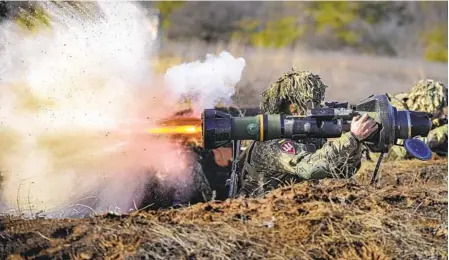  ?? VADIM GHIRDA AP ?? A Ukrainian serviceman fires an anti-tank weapon during an exercise in the Joint Forces Operation in the Donetsk region of eastern Ukraine on Tuesday. Ukrainian officials suggested this week that their country’s aspiration to join NATO could be up for negotiatio­n.