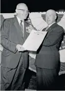  ?? AP ?? Secretary of the Navy Charles Thomas (right) presents George Halas with the Distinguis­hed Service Cross in 1956.