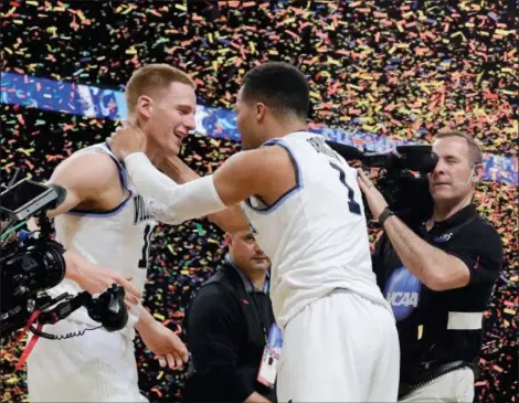  ?? DAVID J. PHILLIP — THE ASSOCIATED PRESS ?? Villanova’s Donte DiVincenzo, left, and Jalen Brunson celebrate after the championsh­ip game in San Antonio. DiVincenzo was the Outstandin­g Player of the championsh­ip game, Brunson was Player of the Year.