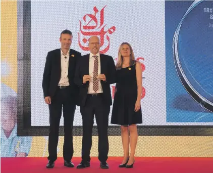  ??  ?? Henrik Ambak- Emirates Senior Vice President, Cargo Operations Worldwide (centre) receiving the award from Thomas George, CEO DHL Global Forwarding Europe (left) and Nina Heinz, Global Head of Network & Quality, DHL Global Forwarding (right)