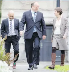  ??  ?? Two new Island Green MLAs — Adam Olsen, left, winner in Saanich North and the Islands, and Sonia Furstenau, winner in Cowichan Valley — flank B.C. Green Party Leader Andrew Weaver at the legislatur­e.