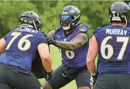  ?? ?? The Ravens responded to a late-season collapse by signing one of the league’s most reliable right tackles, Morgan Moses, above, and drafting a new starting center, Tyler Linderbaum, in the first round.