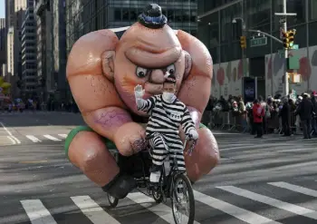  ?? Jeenah Moon, The Associated Press ?? The Tough Guy tricycle balloon escapes down Sixth Avenue. The parade returned in full after being crimped by the pandemic last year.