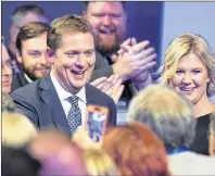  ?? CP PHOTO ?? Conservati­ve Party of Canada leader Andrew Scheer and his wife Jill head through the crowd as he prepares to address the party’s national policy convention in Halifax on Friday.