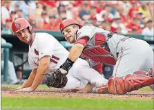  ?? ASSOCIATED PRESS] [JEFF ROBERSON/THE ?? The Cardinals’ Paul DeJong is tagged out at home by Reds catcher Devin Mesoraco during the second inning.