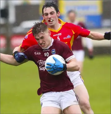  ??  ?? Jake Firman of St. Martin’s is challenged by Horeswood defender Eddie Shiely.