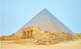  ??  ?? The entrance to the tomb of Queen Meresankh III, with the Pyramid of Khufu in the background, Giza, Egypt. Photograph: eFesenko/Alamy Stock Photo