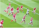  ??  ?? Iconic picture: Manu Tuilagi leaves Welsh defenders trailing in his wake