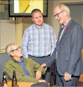  ?? NATHAN ROCHFORD/THE GUARDIAN ?? Cecil Villard, right, chats with supporters Tunglam Tran, left, and Marcel Arsenault at his headquarte­rs in Charlottet­own on Monday.