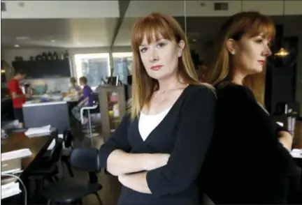  ?? DON RYAN — THE ASSOCIATED PRESS ?? Kim Sordyl poses for a photo at home as her family eats breakfast in the kitchen in Portland, Ore., on July 7. In April, the Portland, Ore., school district filed a lawsuit against Sordyl, who is seeking records about employees on leave for alleged...