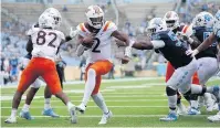  ?? ROBERT WILLETT/ASSOCIATED PRESS ?? Virginia Tech quarterbac­k Hendon Hooker gets past North Carolina’s Tomari Fox to score on a 5-yard carry in the third quarter Saturday at Kenan Stadium in Chapel Hill. The Tar Heels won 56-45.