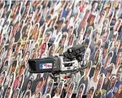  ?? Christian Petersen / Getty Images ?? A TBS camera is seen among the cardboard cutout fans at a game between the Tampa Bay Rays and the New York Yankees at PETCO Park.