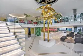  ?? The remodelled lobby with its golden palm trees. ??