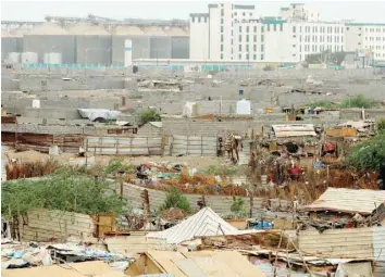  ?? — Reuters ?? Hodeida port’s grain silos are pictured from a nearby shantytown in Hodeida, Yemen, on Saturday.