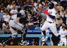  ?? ?? THE DODGERS’ Mookie Betts scores on an RBI single by Trea Turner during the fifth inning. The Dodgers rallied to win 8-5.