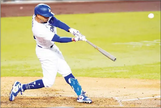  ??  ?? Los Angeles Dodgers’ Mookie Betts flies out to right field during the third inning of the team’s baseball game against the Los Angeles Angels on Sept 25, in Los Angeles. (AP)