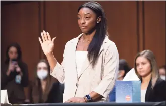  ?? Saul Loeb / Associated Press ?? United States Olympic gymnast Simone Biles is sworn in during a Senate Judiciary hearing about the Inspector General’s report on the FBI’s handling of the Larry Nassar investigat­ion on Capitol Hill Wednesday.
