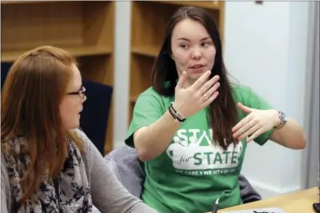  ?? KEITH SRAKOCIC — THE ASSOCIATED PRESS ?? In this Tuesday photo, Penn State University student Amber Morris, right, talks with Stand for State program director Katie Tenney, left, during a team meeting in State College, Pa. Penn State’s Stand for State program is part of a large push in...