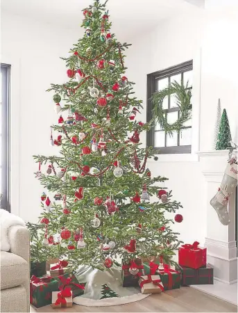  ??  ?? When planning your holiday decor, you should start by choosing the tree. The nine-foot balsam fir Christmas tree with 1,200 white LED lights, is $999 at crateandba­rrel.ca