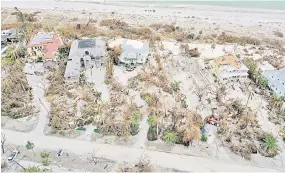  ?? ?? In this aerial view, damaged buildings line the shore line after Hurricane Ian passed through the area in Sanibel, Florida.