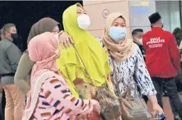  ?? TATAN SYUFLANA/AP ?? Relatives of missing passengers arrive at a crisis center set up Saturday at Soekarno-Hatta Internatio­nal Airport in Tangerang, Indonesia.