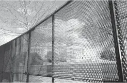  ?? CAROLYN KASTER/AP ?? The U.S. Capitol is seen behind security fencing in April in Washington. Officials have been discussing security plans that involve reconstruc­ting the fence.