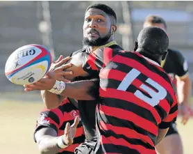  ?? Picture: FREDLIN ADRIAAN ?? LETTING GO: Boland Cavaliers fullback Jacquin Jansen loses possession as he is tackled by EP Elephants centre Siyanda Grey (No 13) in their SuperSport Rugby Challenge match