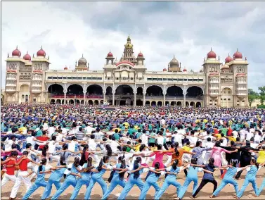  ?? IANS ?? Around 6,000 students from 15 educationa­l institutio­ns participat­e in the longest yoga chain arranged by the district administra­tion and Mysore Palace Board at the Mysore Palace ahead of Internatio­nal Day of Yoga, in Mysore on Saturday.