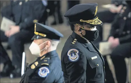  ?? ERIN SCHAFF — THE NEW YORK TIMES VIA AP ?? Capitol Police Acting Chief Yogananda Pittman departs a ceremony memorializ­ing U.S. Capitol Police officer Brian Sicknick, as an urn with his cremated remains lies in honor on a black-draped table at the center of the Capitol Rotunda, Feb. 3, in Washington.