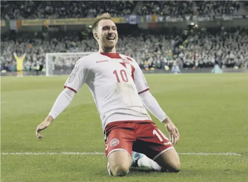  ??  ?? 0 Christian Eriksen, who scored a hat-trick in Dublin last night, celebrates after finding the Irish net in Denmark’s 5-1 victory.