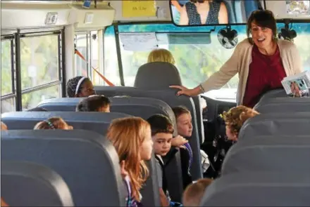  ?? PETE BANNAN — DIGITAL FIRST MEDIA ?? Laurie Aguilara, a representa­tive of the Highway and Safety Department of PennDOT, speaks to children riding the school bus to Mary C. Howse Elementary School about bus safety as part of Operation “Safe Stop.” Operation “Safe Stop” is part of National...