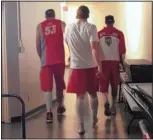  ?? GEOFF GRAMMER/JOURNAL ?? From left, Alex Kirk, Cameron Bairstow and Kendall Williams enter a tunnel at the Thomas & Mack Center after winning the MWC tourney.