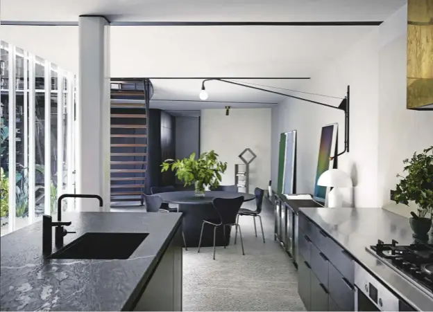  ??  ?? this page: in the kitchen/dining area, Zip HydroTap 5-in-1 BCSHA G4 Arc in Matt Black from E& S Trading; BOSCH cooktop; MOLTENI Strand sideboard from Hub Furniture Lighting Living. opposite page: kitchen island in Titanium Black granite from CDK Stone;...