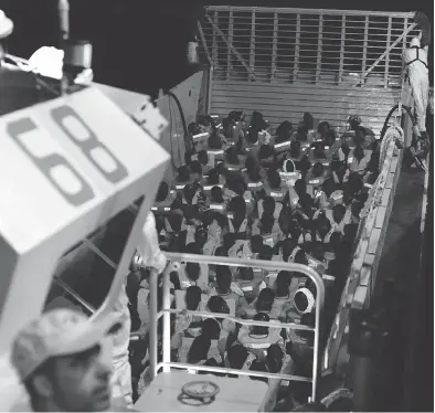  ?? KENNY KARPOV / SOS MEDITERRAN­EE VIA THE ASSOCIATED PRESS ?? Migrants prepare to board the SOS Mediterran­ée’s Aquarius ship in the Mediterran­ean. Spain has offered to take the 629 asylum seekers rescued at sea by the Aquarius after Italy and Malta refused to take them.