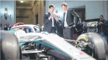  ?? — AFP photo ?? Ratcliffe (right) Wolff react during a media event to reveal the team’s new livery for the upcoming 2020 season, at the Royal Automobile Club in London.