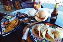  ??  ?? Shrimp tacos and a beer for lunch at the Puerto Magdalena whale camp, in Mexico.