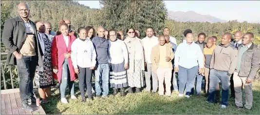  ?? (Courtesy pics) ?? Lawyer Sidumo Mdladla of SV Mdladla and Associates presenting a gift to Patricia Masemola during her farewell. (R) The staff of SV Mdladla and Associates pose for a group photo during the farewell function of two of their colleagues.