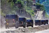  ??  ?? Army trucks move towards Ladakh via Leh– Manali Highway in Manali on Monday.