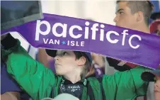  ??  ?? Ten-year-old Ruairidh Shaw holds the team’s purple banner.