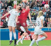  ?? MIGUEL ROJO GETTY IMAGES ?? Canada’s Jessica de Filippo, centre, goes up for the ball between New Zealand’s Mackenzie Barry and Hannah Mackay-Wright.